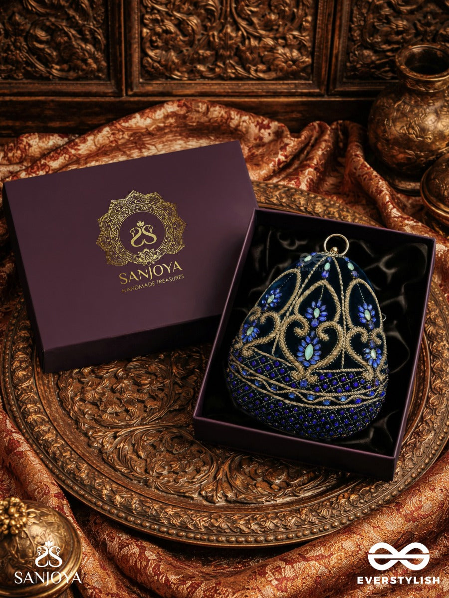 Sitaraa – Polished Oval Royal Blue Velvet Clutch With Stone-Accented Handwork And Golden Metal Frame
