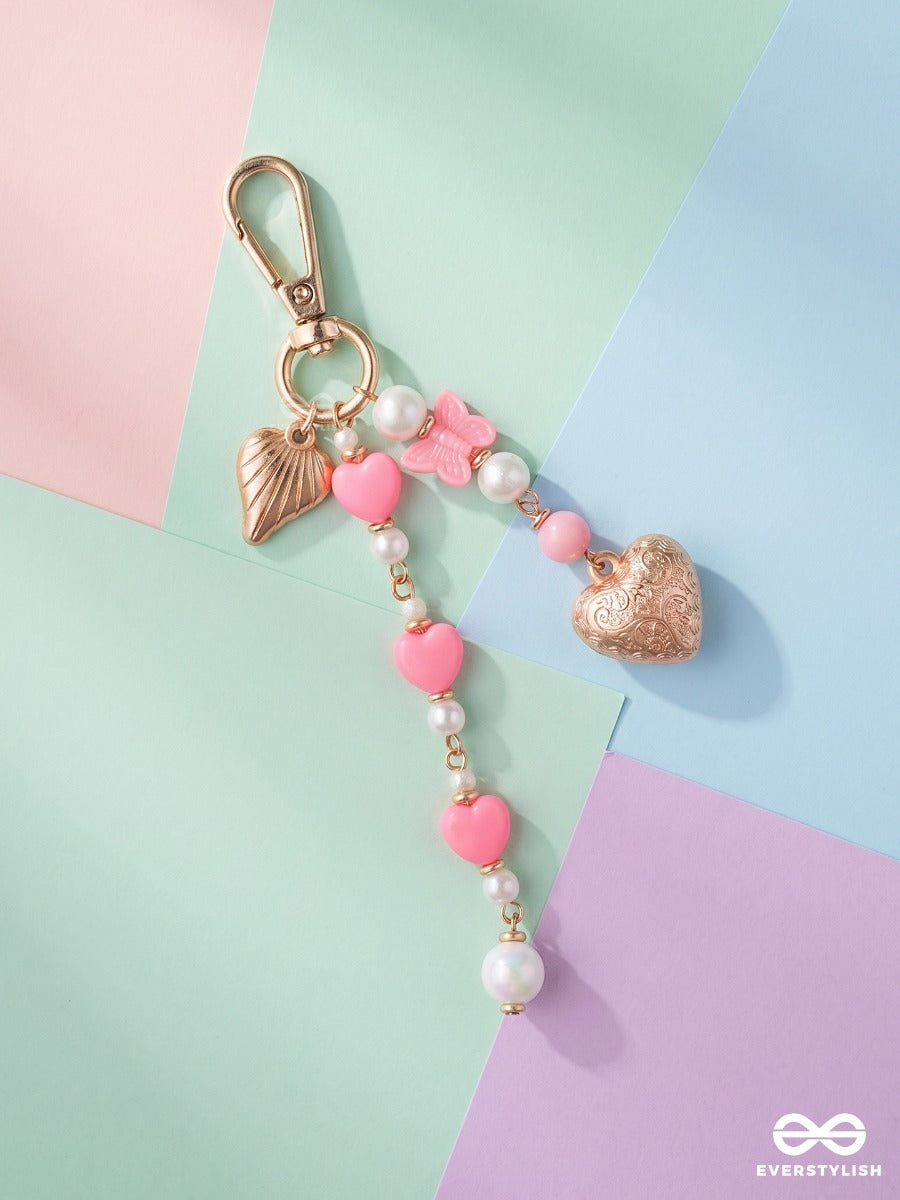 Heart Wings – Winged Heart Bag Charm With Pink And White Bead Details