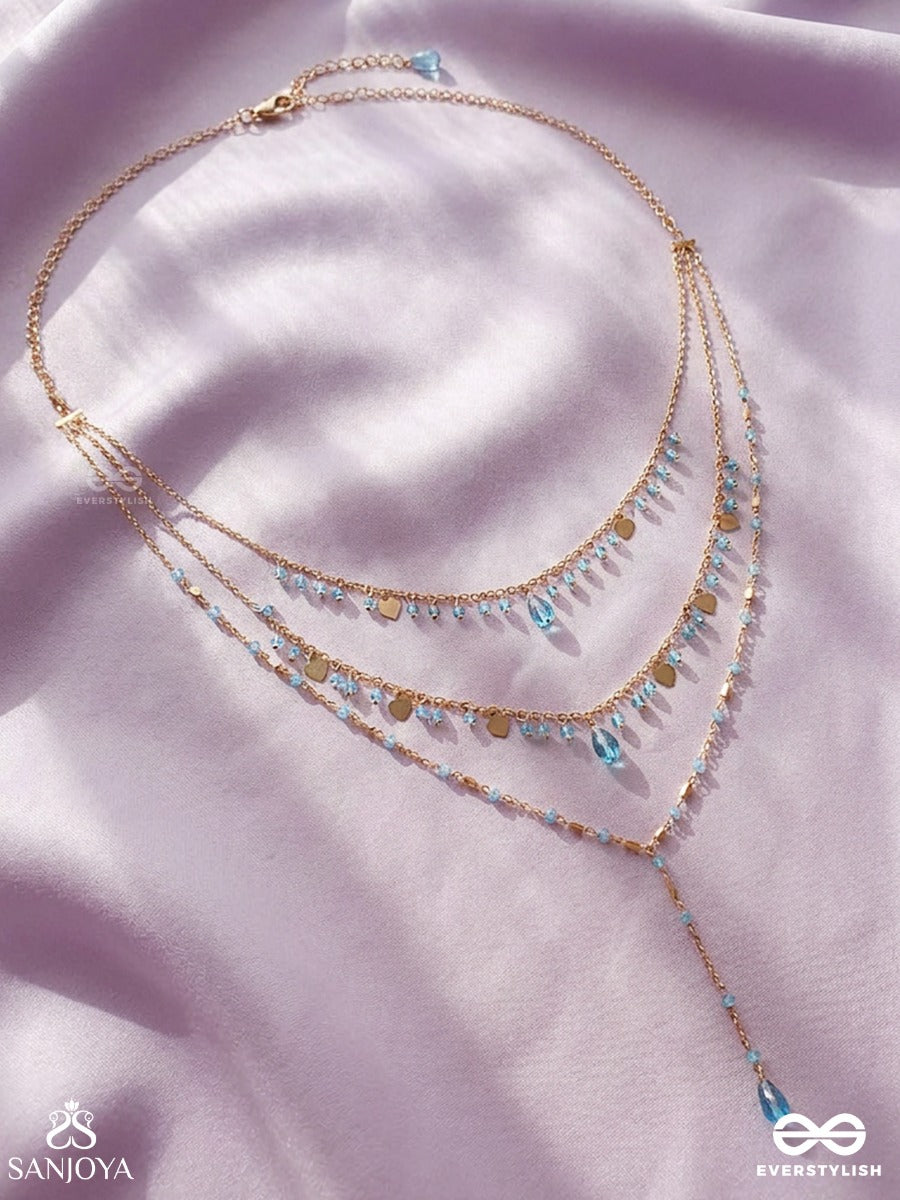 Sky Ripple – Triple-Layered Gold-Tone Necklace With Turquoise Bead Accents