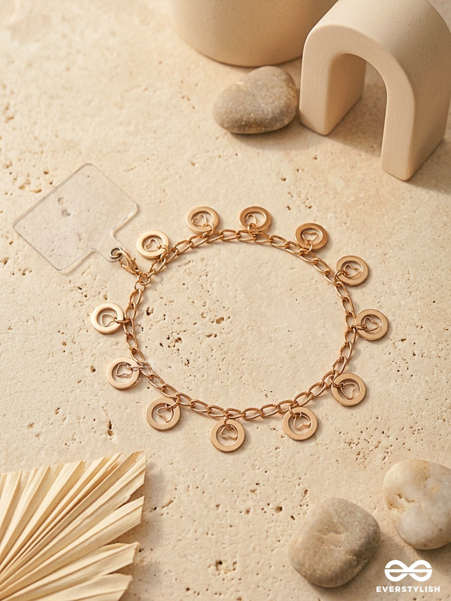 Curl Code – Gold-Tone Phone Sling With Curly Charms