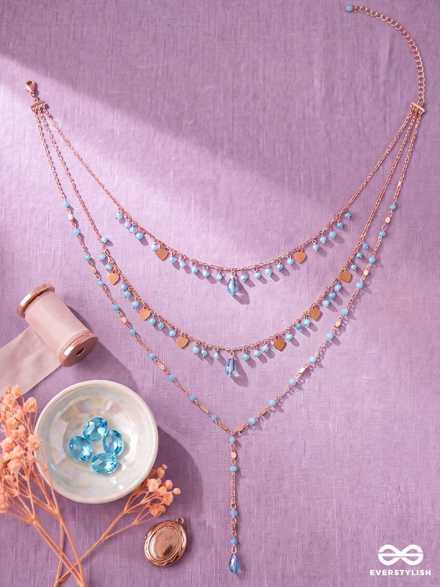 Sky Ripple – Triple-Layered Gold-Tone Necklace With Turquoise Bead Accents