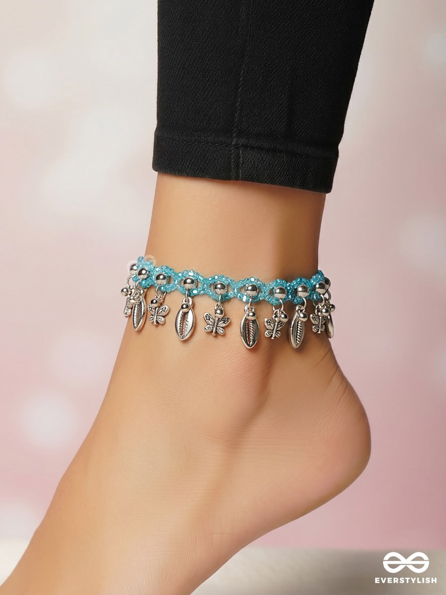 Coastal Jingle – Sky Blue Thread Anklet (Single) With Cowrie Shells And Floral Charms
