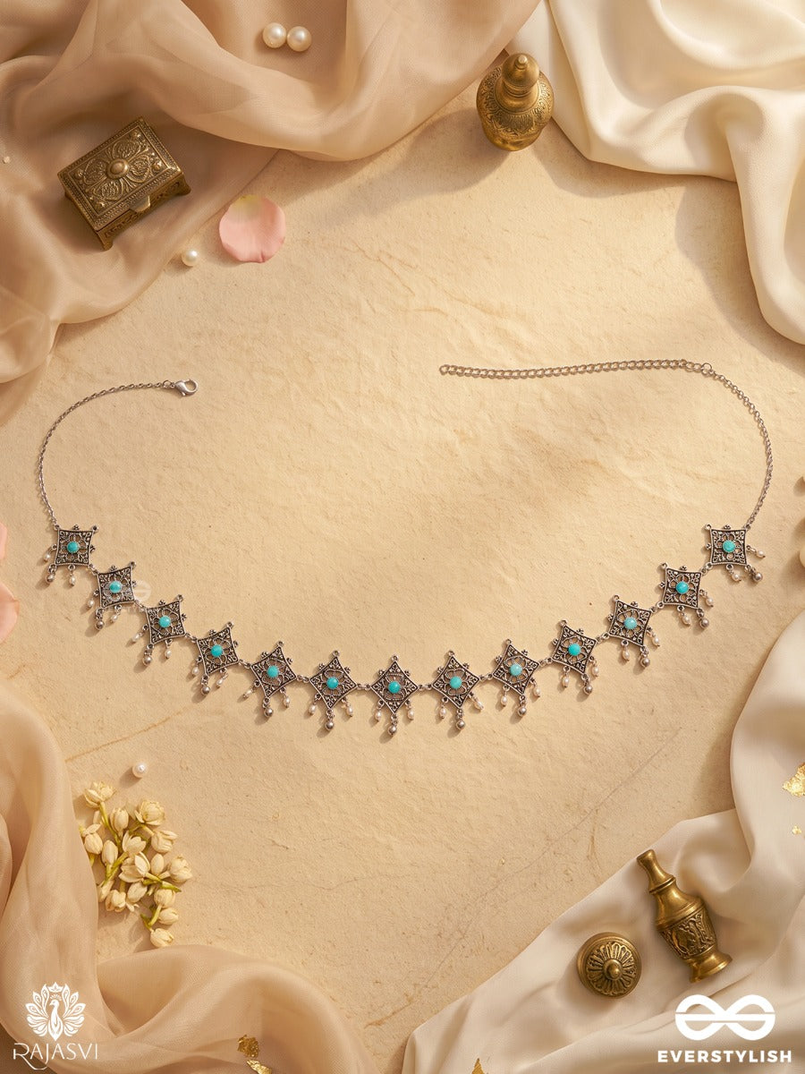 Parnavi – Oxidised Waist Chain With Floral Motifs And Green Stone Accents