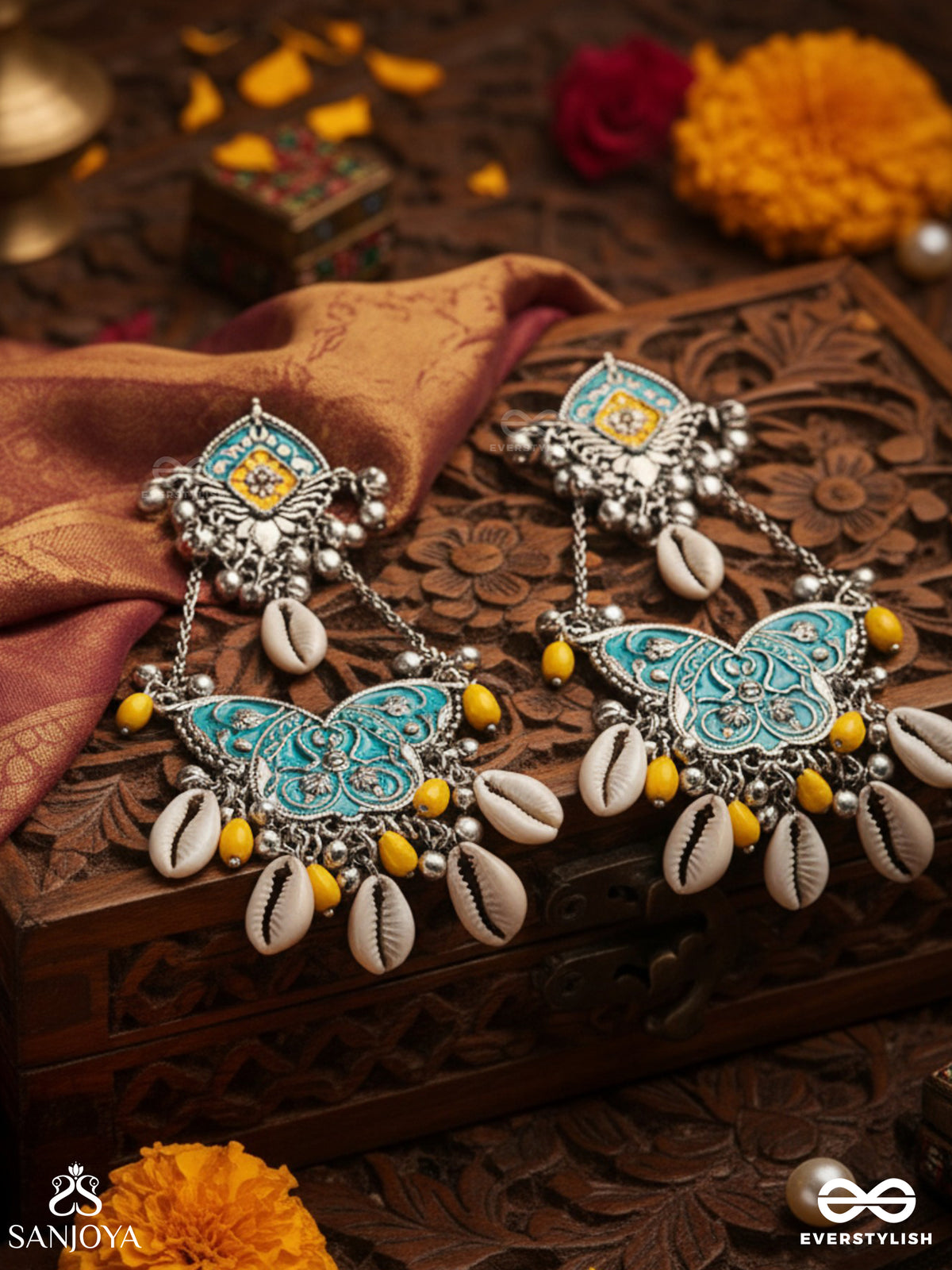 Shankha Pushpa- Conch Blossom-Oxidized Earrings With Pastel-Hued Metalwork, Embellished With Delicate Cowrie Shells, Yellow Beads And Ghungroo