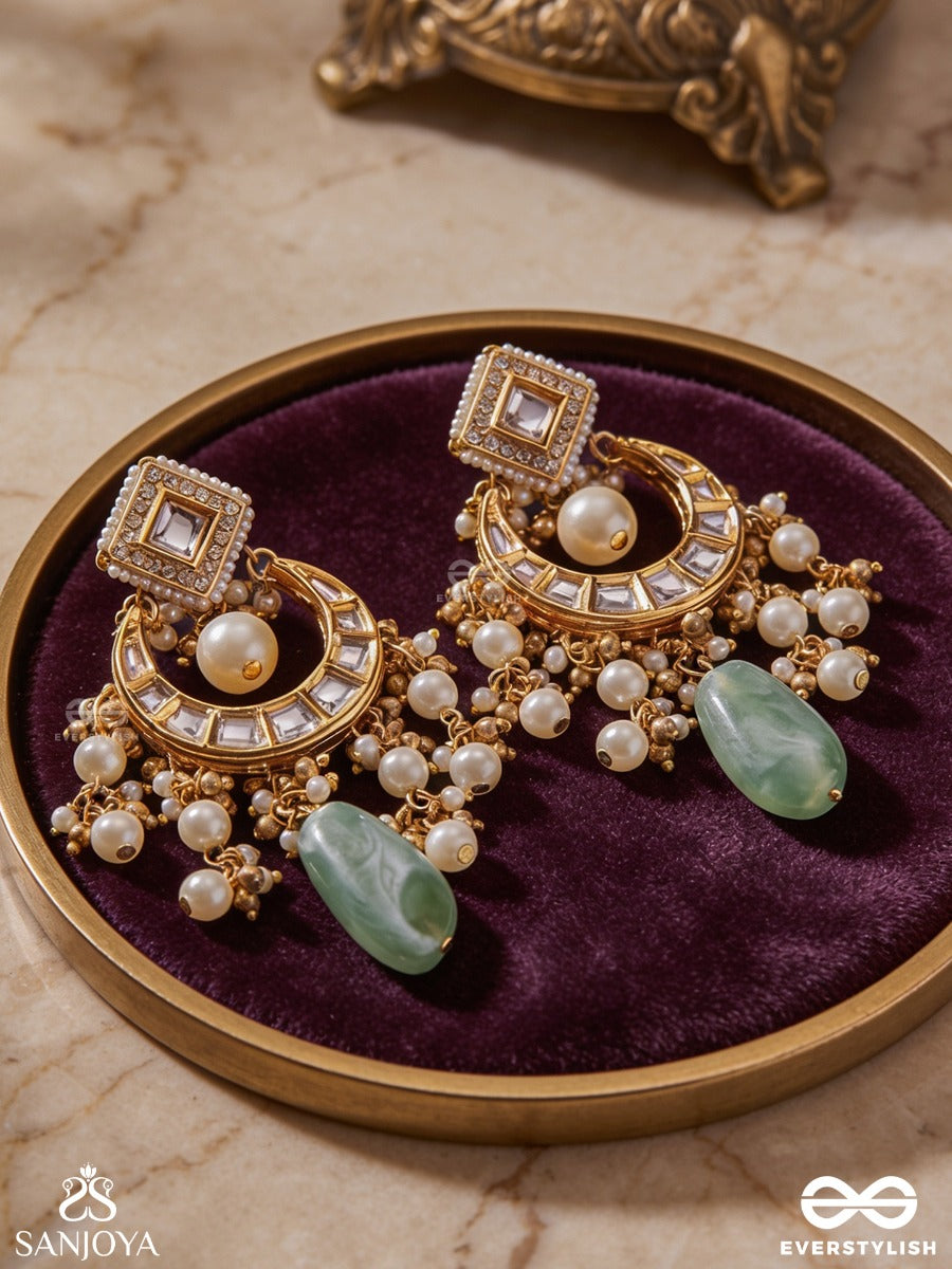 Purnima Phool - Full Moon Flower An Exquisite Kundan Earring Featuring Golden Designs, Pearl Clusters, And A Green Gemstone Drop, Symbolizing Elegance