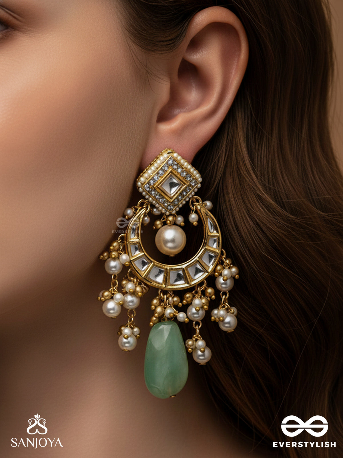 Purnima Phool - Full Moon Flower An Exquisite Kundan Earring Featuring Golden Designs, Pearl Clusters, And A Green Gemstone Drop, Symbolizing Elegance