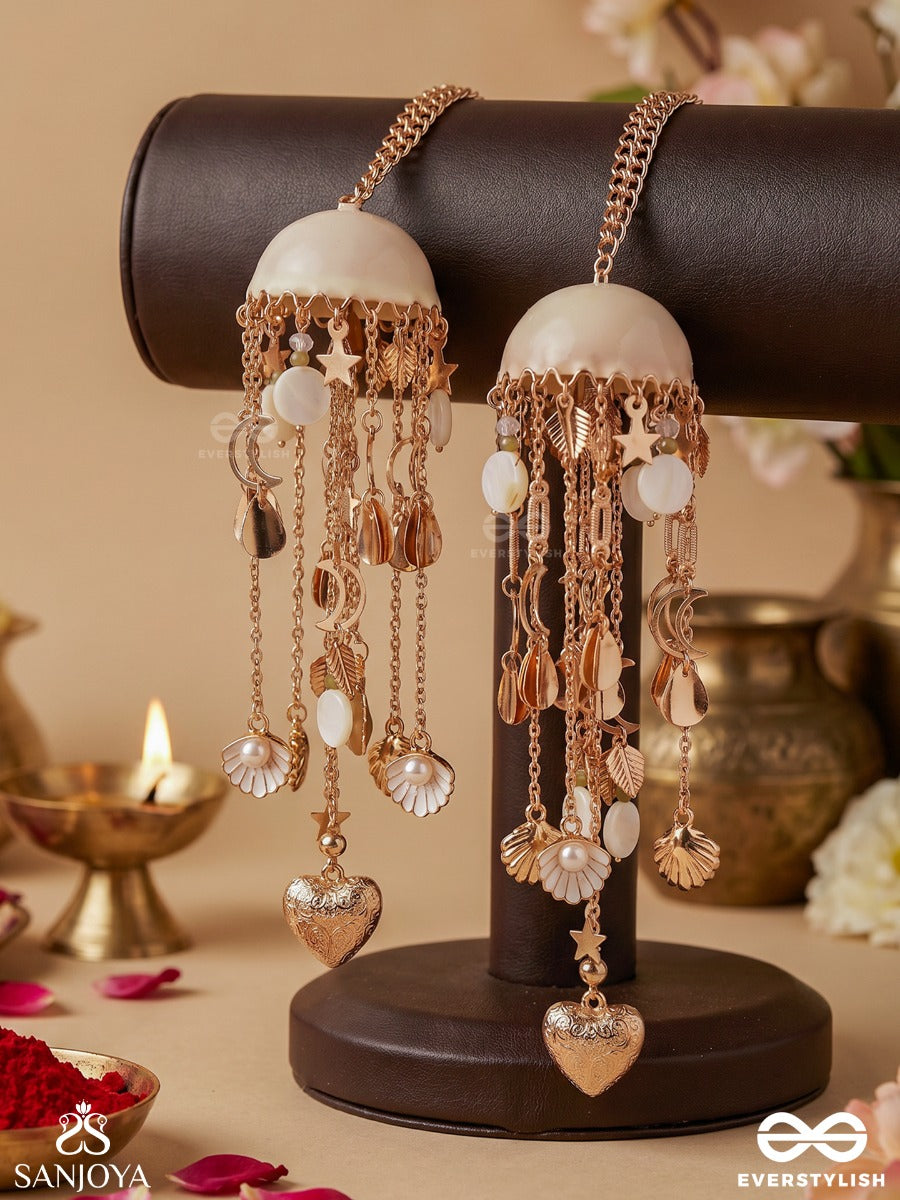 Dhariniya – Grace In Flow – Festive Kaleera With Layered Chain Strands, Floral White Elements And Delicate Metallic Hangings