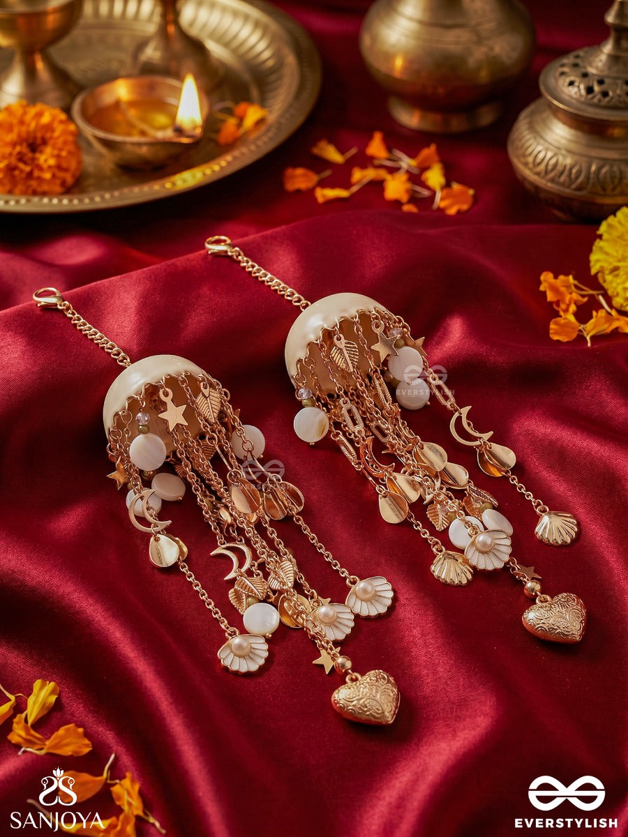 Dhariniya – Grace In Flow – Festive Kaleera With Layered Chain Strands, Floral White Elements And Delicate Metallic Hangings
