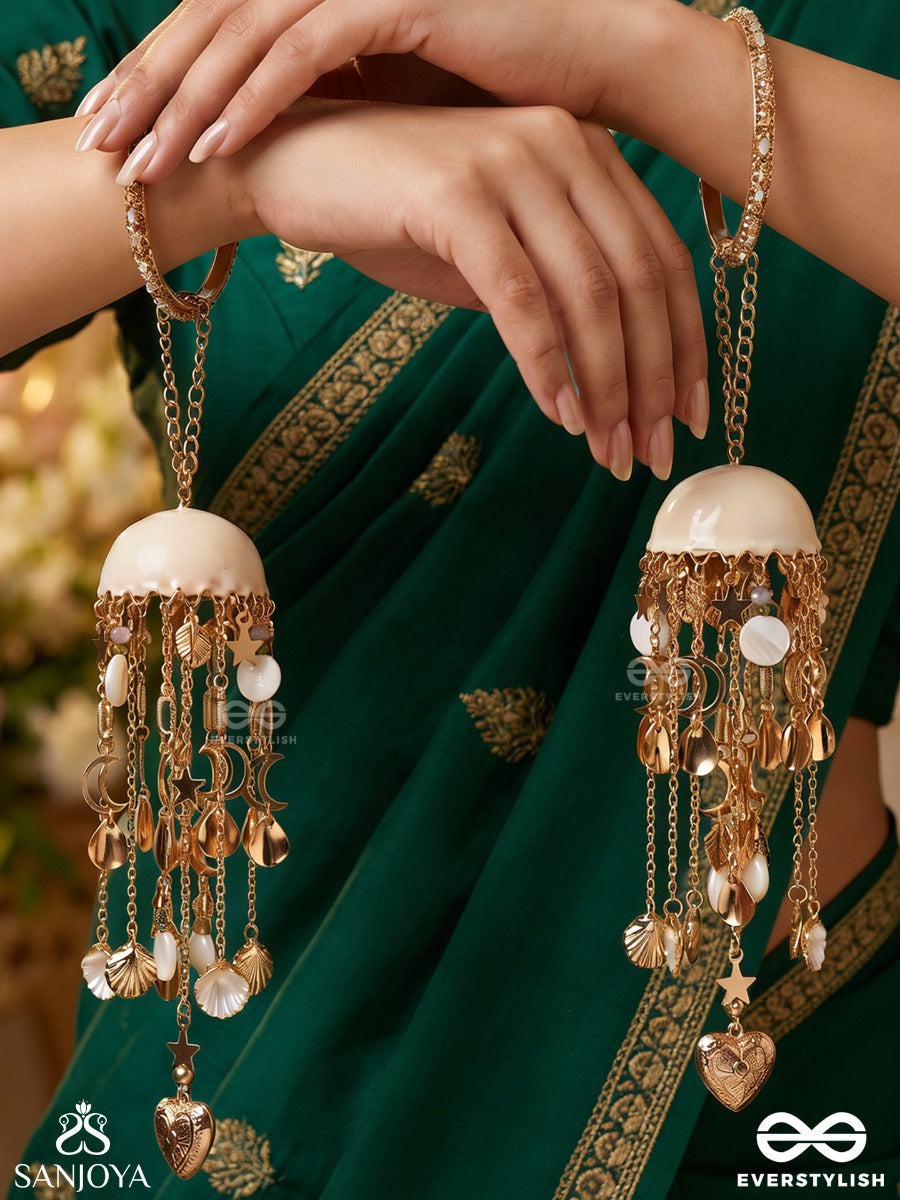 Dhariniya – Grace In Flow – Festive Kaleera With Layered Chain Strands, Floral White Elements And Delicate Metallic Hangings