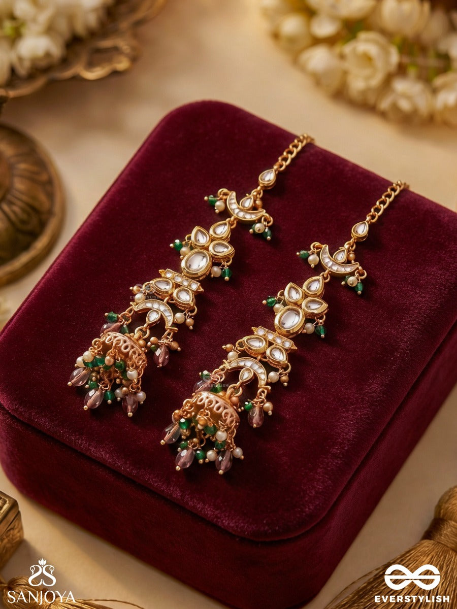 Ojasvini – Radiant Splendour – Straight Kaan Chain Earrings With Leaf-Like Stone Motifs, Deep Blue Accents, Pearl Details And Ornate Hanging Jhumka Ends