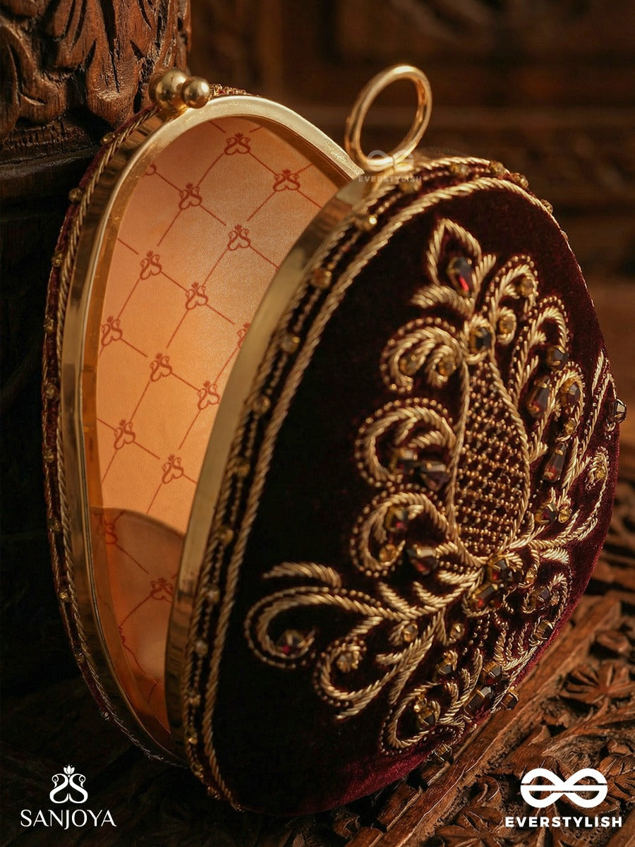 Noor – Oval Maroon Velvet Clutch With Rich Zardozi Embroidery And Golden Metal Frame