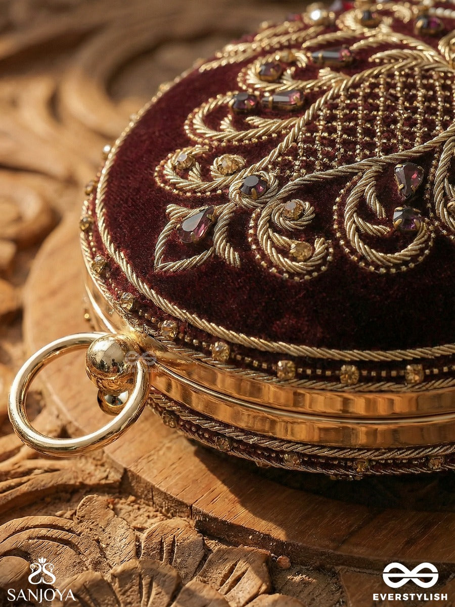 Noor – Oval Maroon Velvet Clutch With Rich Zardozi Embroidery And Golden Metal Frame