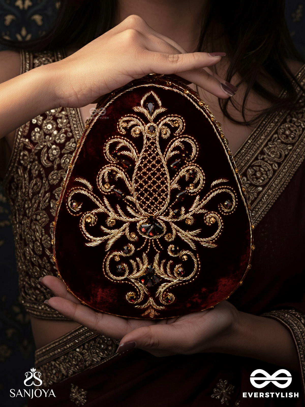 Noor – Oval Maroon Velvet Clutch With Rich Zardozi Embroidery And Golden Metal Frame