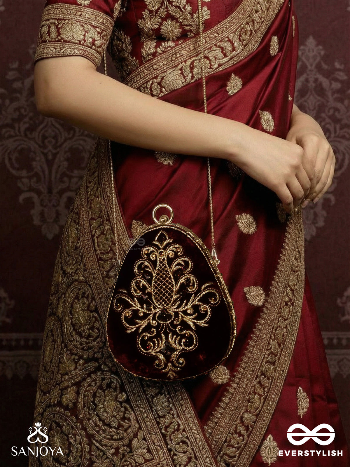 Noor – Oval Maroon Velvet Clutch With Rich Zardozi Embroidery And Golden Metal Frame