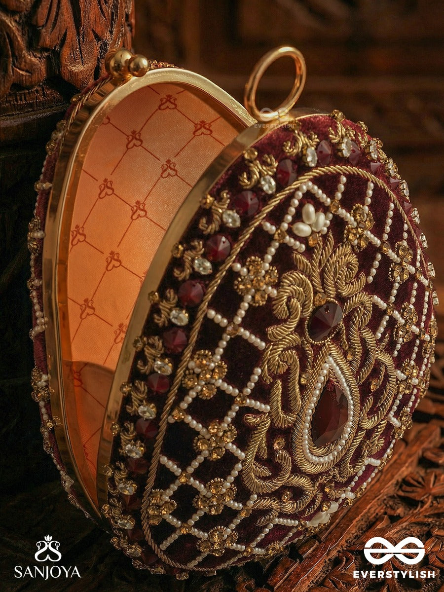 Shahnaz – Oval Maroon Velvet Clutch With Intricate Zardozi Embroidery And Golden Metal Frame