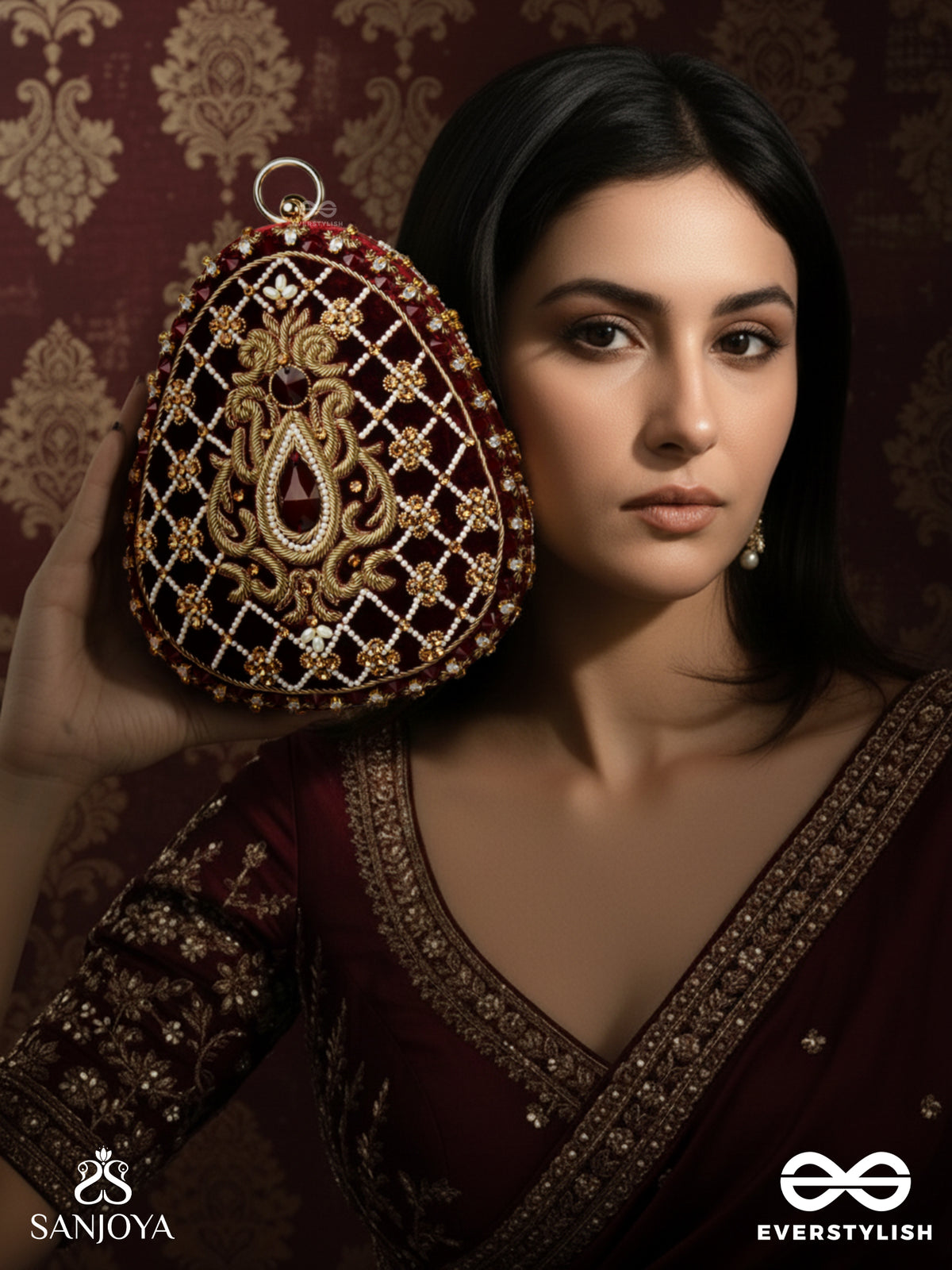 Shahnaz – Oval Maroon Velvet Clutch With Intricate Zardozi Embroidery And Golden Metal Frame