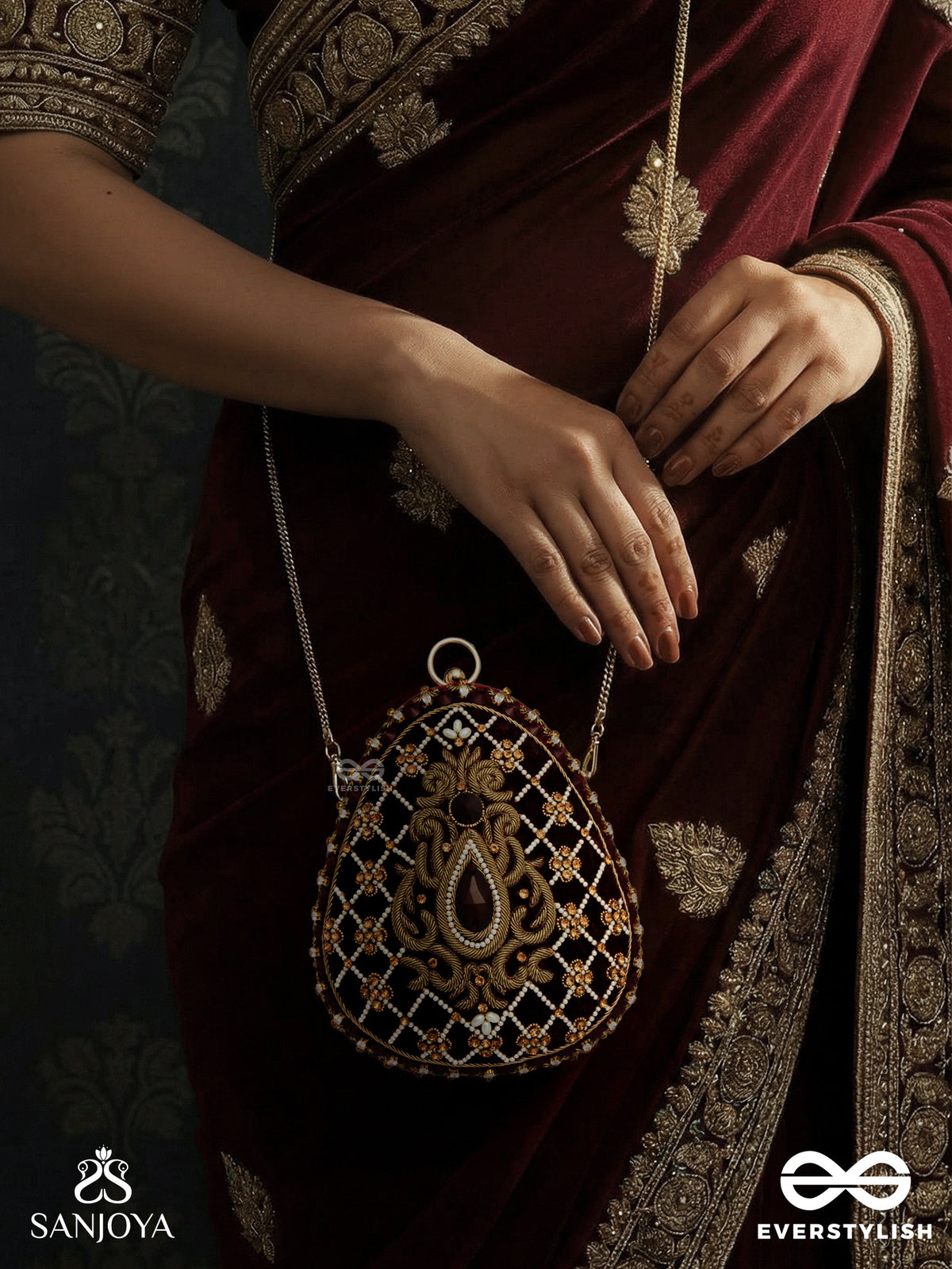 Shahnaz – Oval Maroon Velvet Clutch With Intricate Zardozi Embroidery And Golden Metal Frame
