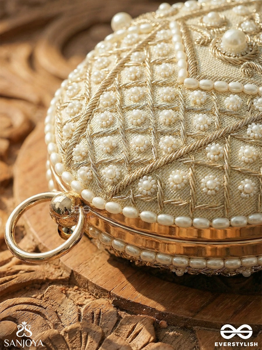 Sahiba – Oval Ivory Silk Clutch With Pearl Embedding And Golden Metal Frame