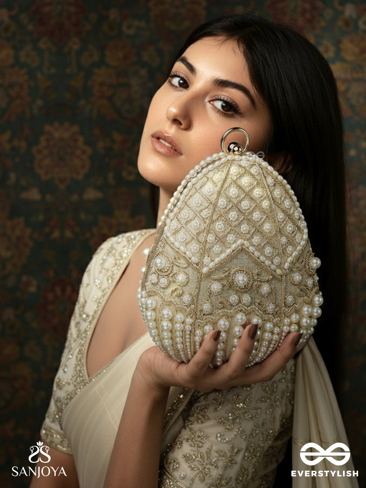 Sahiba – Oval Ivory Silk Clutch With Pearl Embedding And Golden Metal Frame