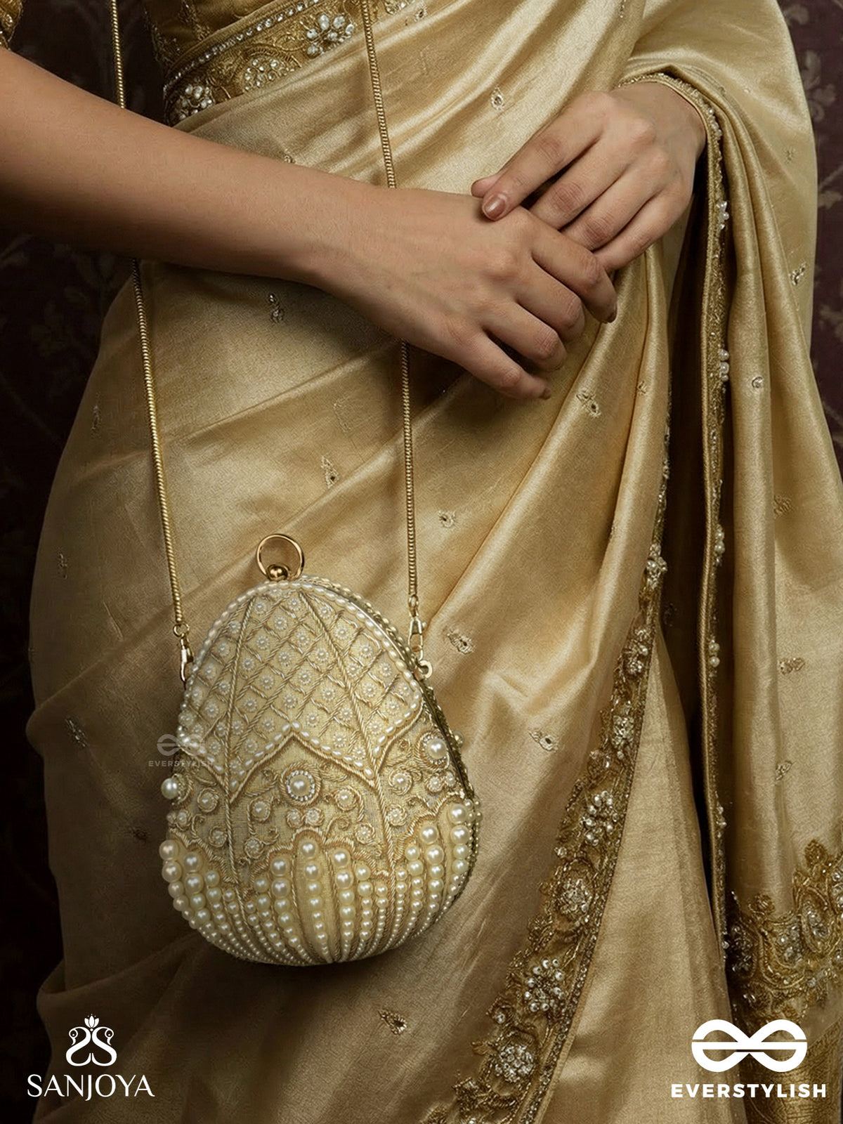 Sahiba – Oval Ivory Silk Clutch With Pearl Embedding And Golden Metal Frame