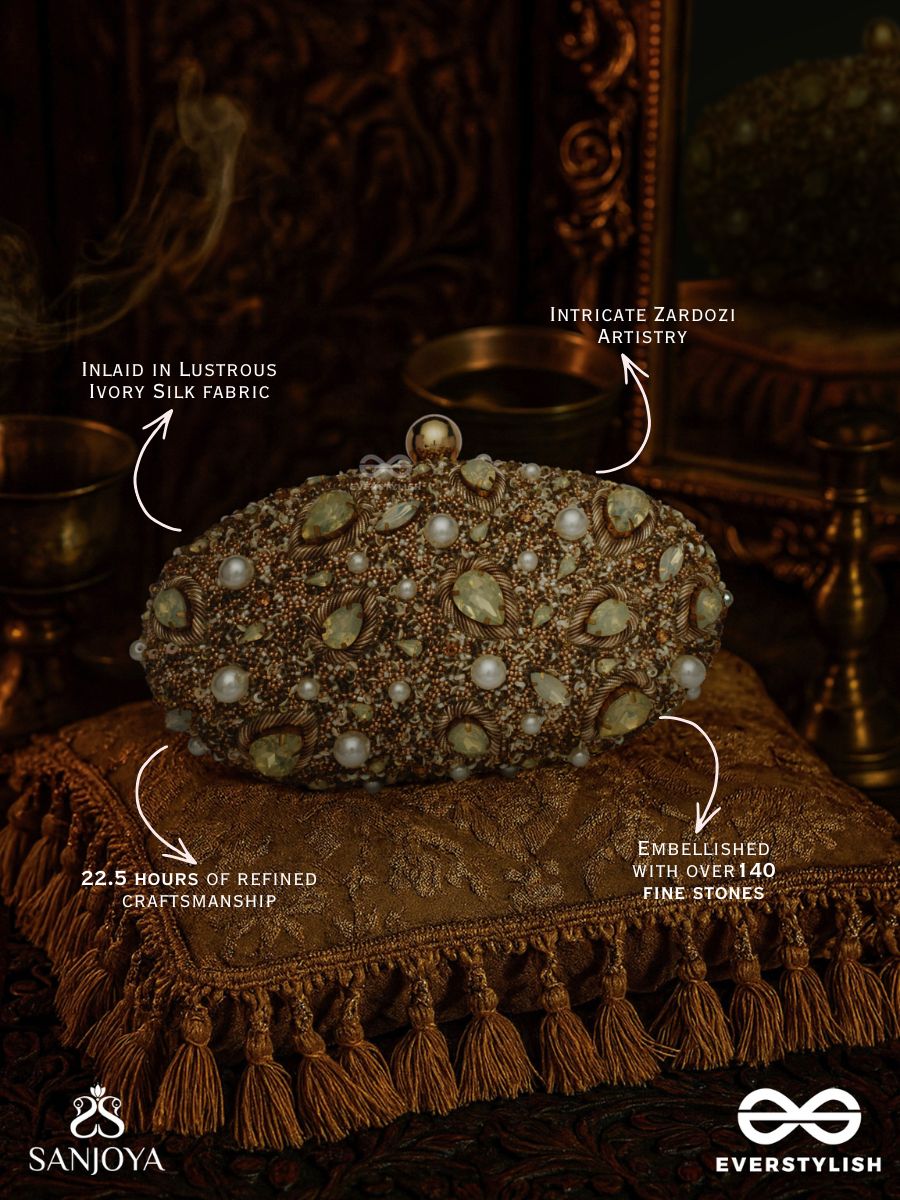Chandraaya – Polished Oval Golden Bronze Silk Clutch With Intricate Jewel Stone Embellishment And Golden Metal Frame