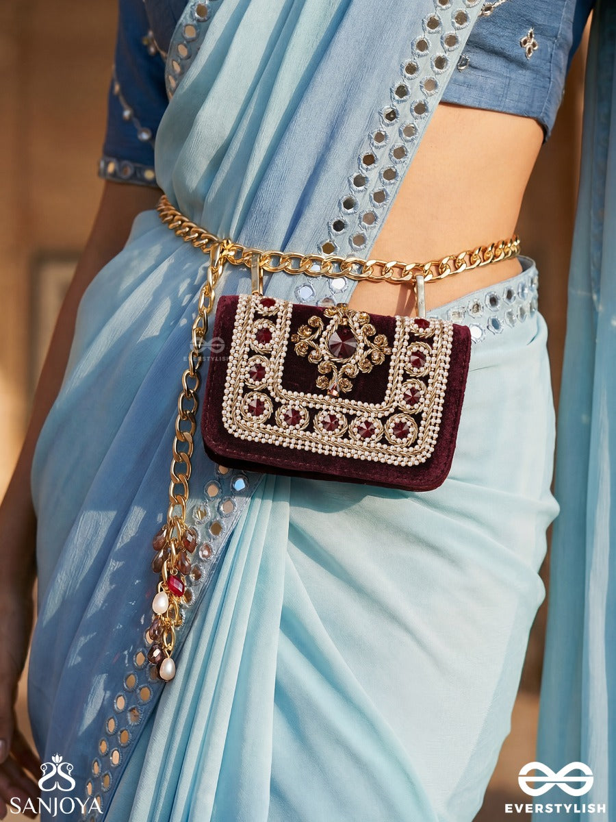 Vilasini – Rectangular Wine Velvet Clutch With Ornate Gem Embellishment, Pearl Framework And Charm Detail