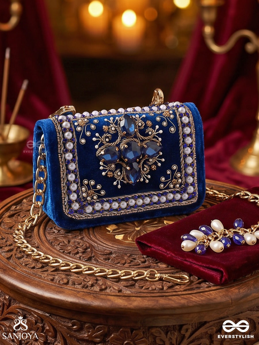 Kadambari – Rectangular Royal Blue Velvet Clutch With Ornate Gem Embellishment, Pearl Framework And Tassel Detail