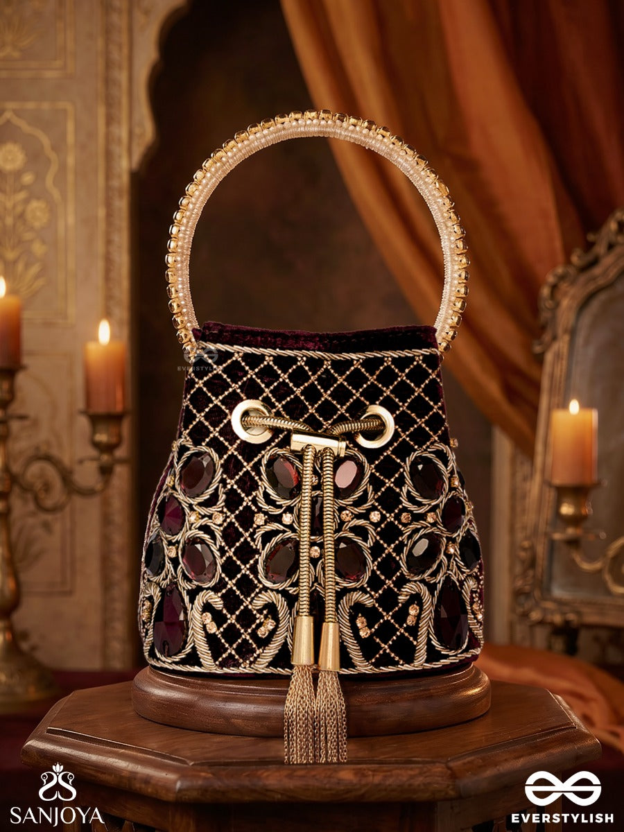 Zareen – Bucket Rich Maroon Velvet Bag With Mirror Gridwork, Braided Cord Closure And Embellished Grip Handle