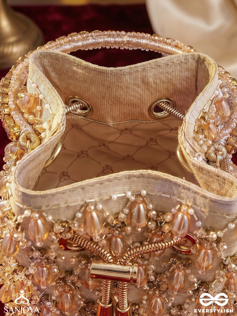 Rumana – Bucket Pale Champagne Base Bag With Cascade Pearl Detailing, Cord Lock And Embellished Handle
