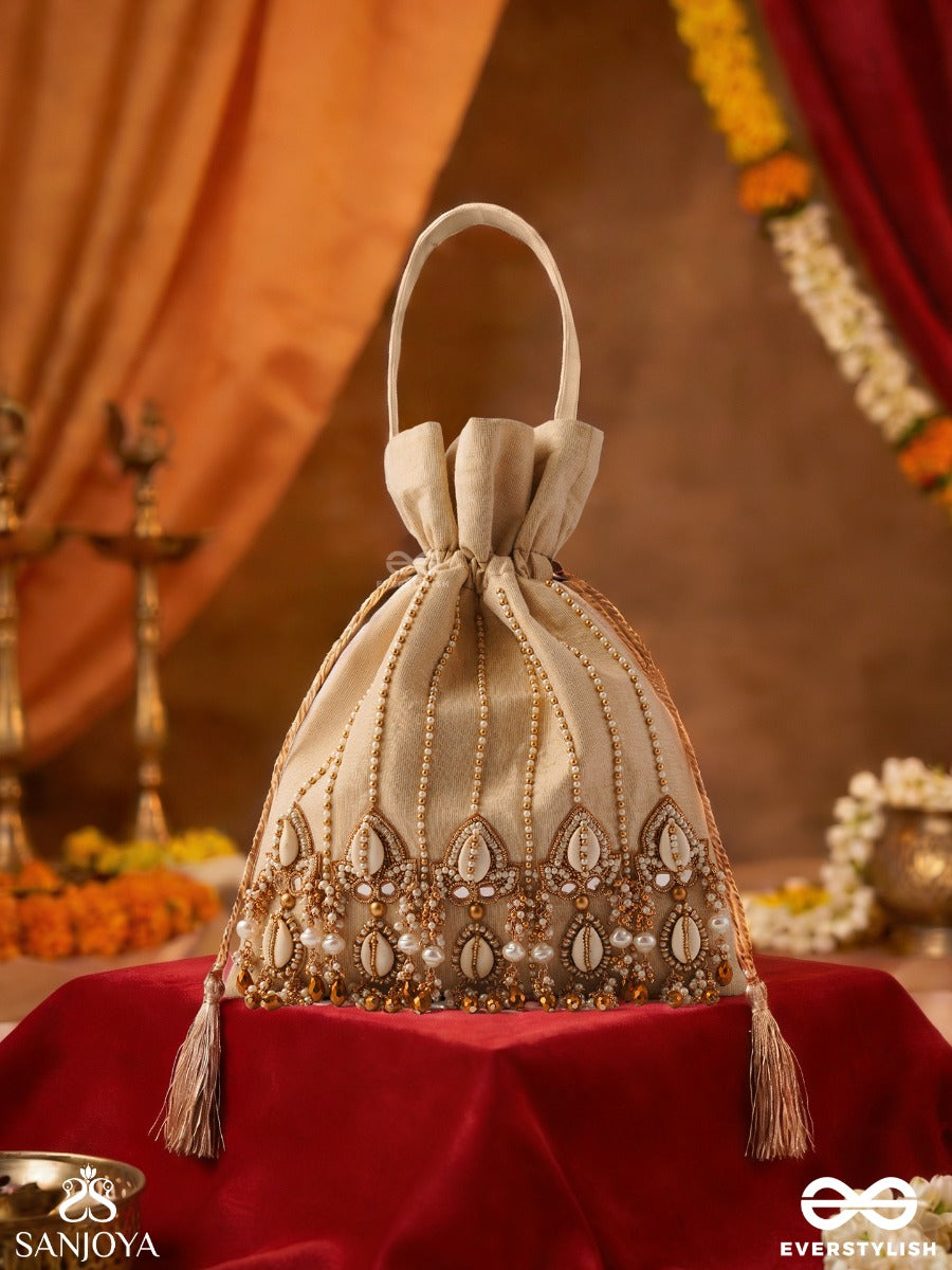 Yasmeenah – Potli Light Champagne Bag With Handplaced Pearl Hangings, Ornamental Thread Accents And Braided Ties