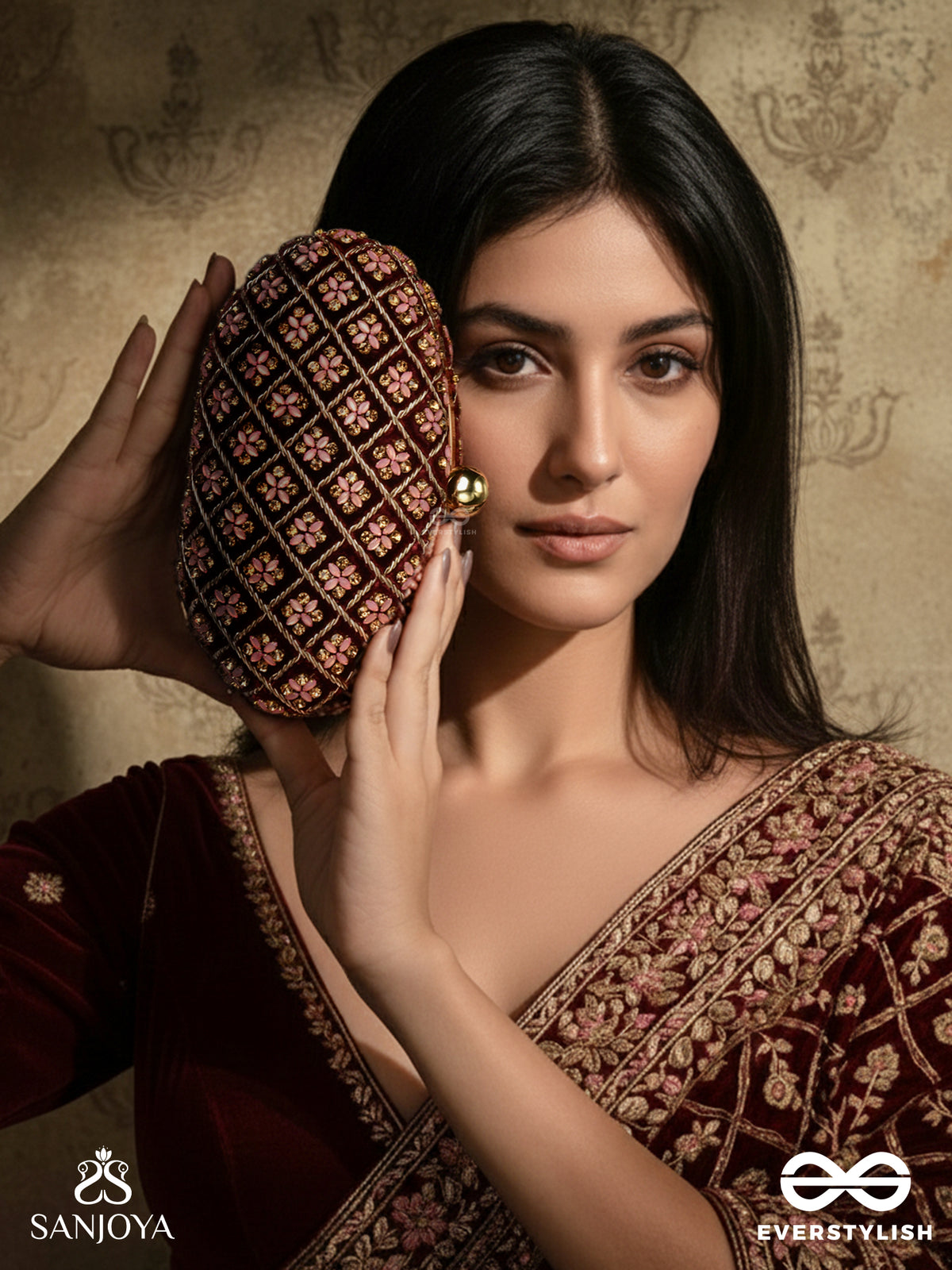 Nazrana – Curved Maroon Shade Textile Clutch With Ornamented Grid Embellishment And Golden Metal Frame