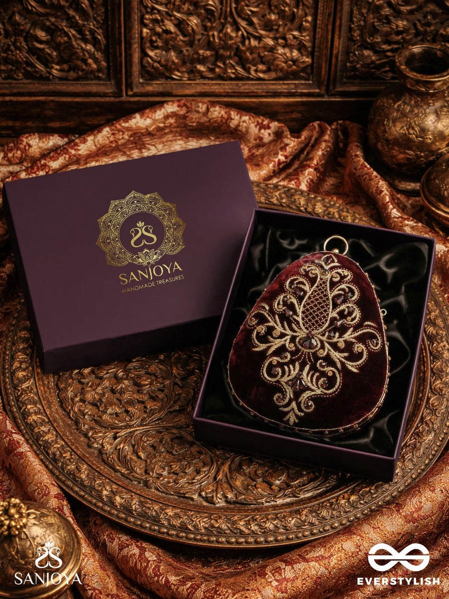 Noor – Oval Maroon Velvet Clutch With Rich Zardozi Embroidery And Golden Metal Frame