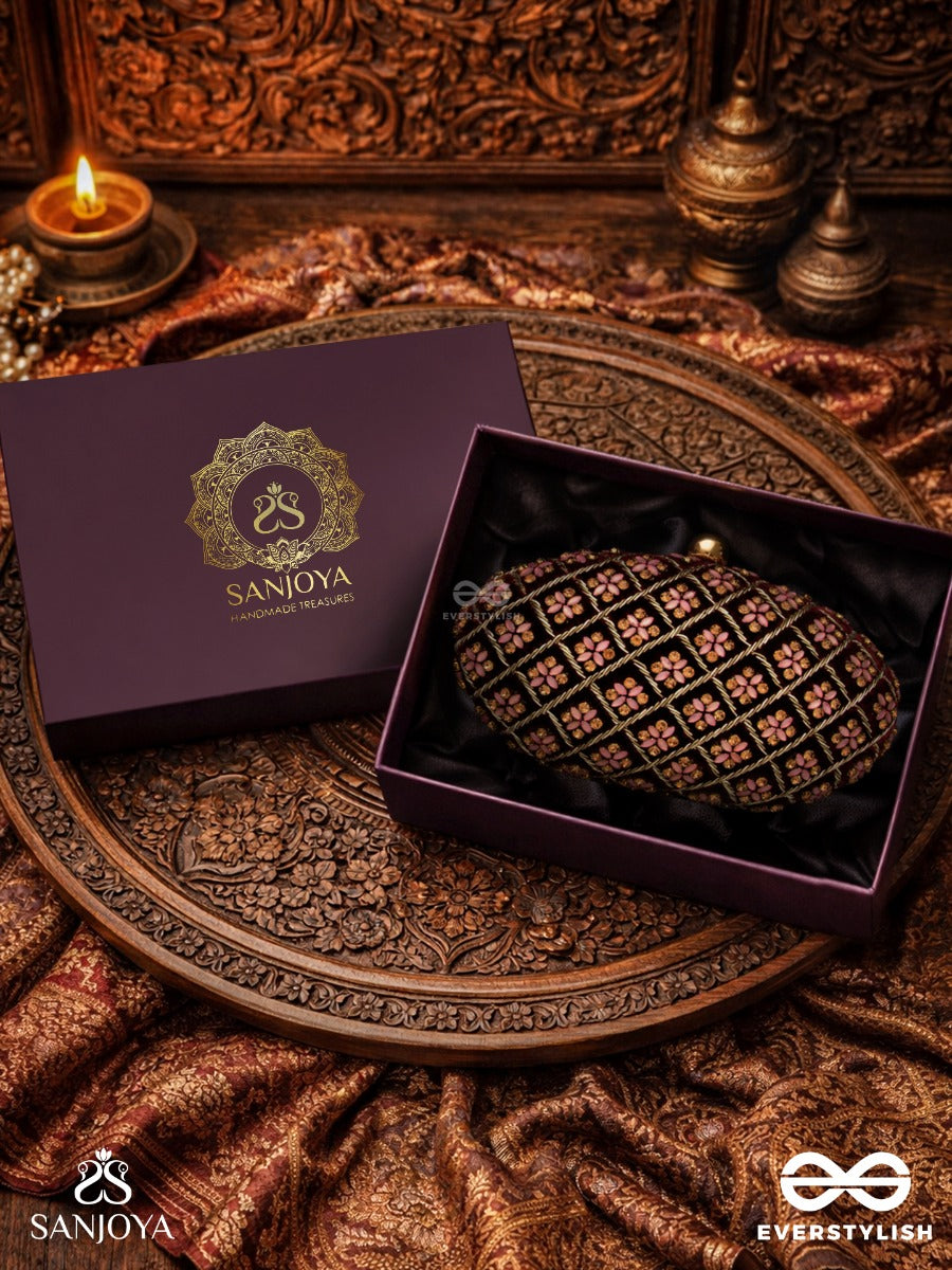 Nazrana – Curved Maroon Shade Textile Clutch With Ornamented Grid Embellishment And Golden Metal Frame