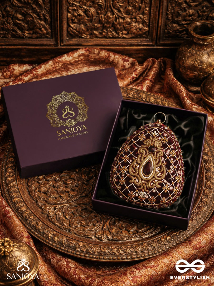 Shahnaz – Oval Maroon Velvet Clutch With Intricate Zardozi Embroidery And Golden Metal Frame