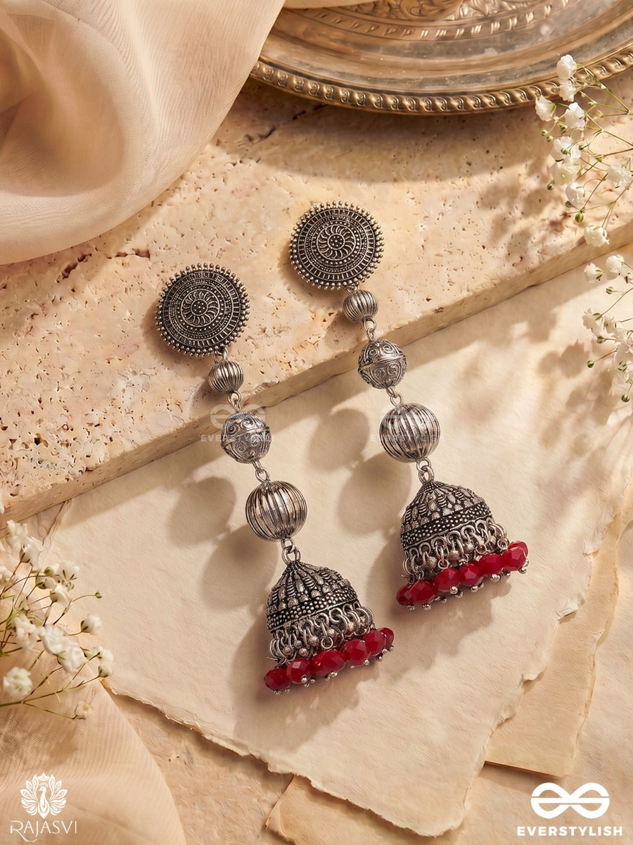 Suryakala – Oxidised Tiered Jhumka Earrings With Radiant Disc Motifs And Ruby Bead Fringe