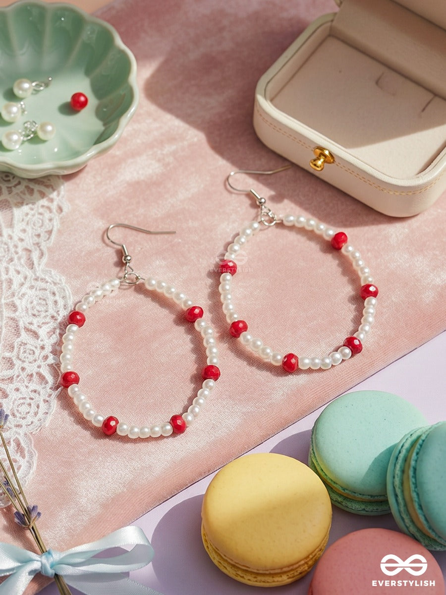 Snow & Ruby – Pearl Oval Hoop Earrings With Crimson Bead Accents