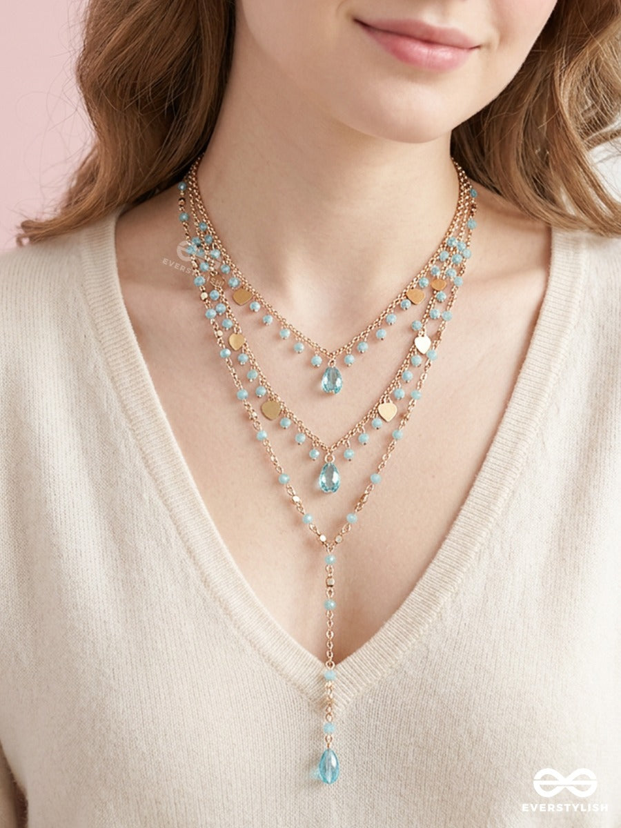 Sky Ripple – Triple-Layered Gold-Tone Necklace With Turquoise Bead Accents