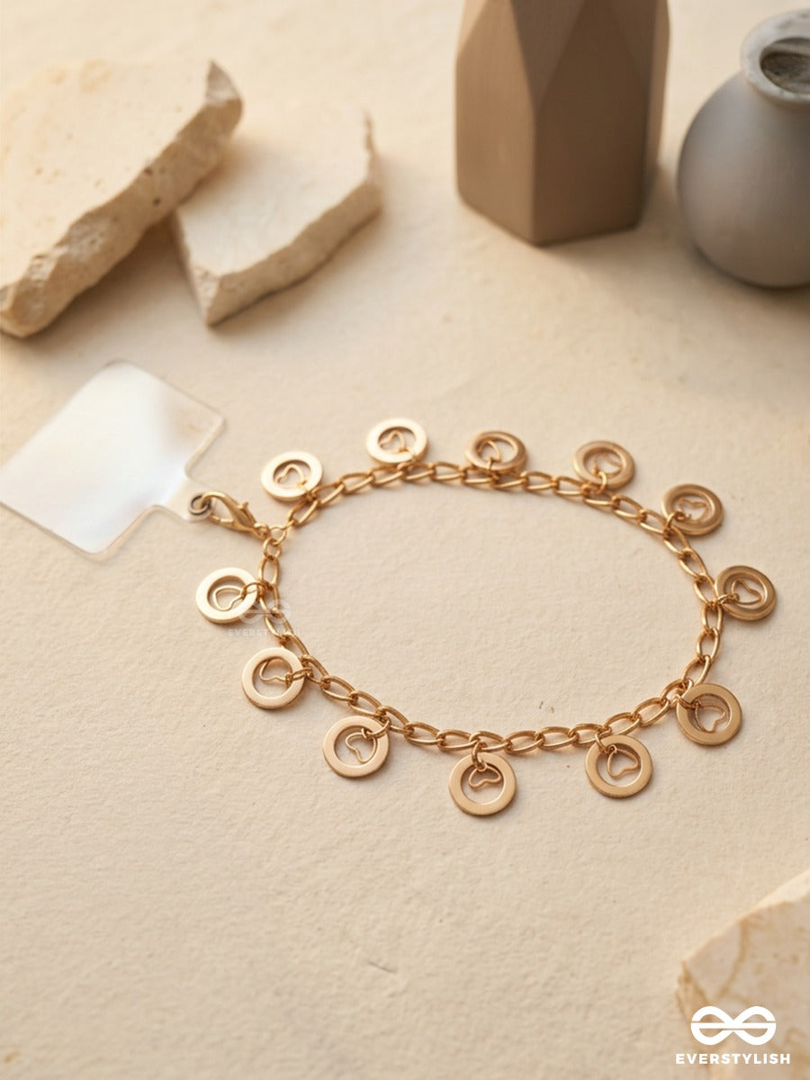 Curl Code – Gold-Tone Phone Sling With Curly Charms