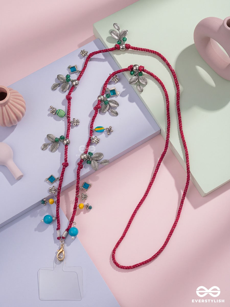 Madhuban – Magenta Braided Phone Sling With Oxidised Floral Charms And Turquoise Beads
