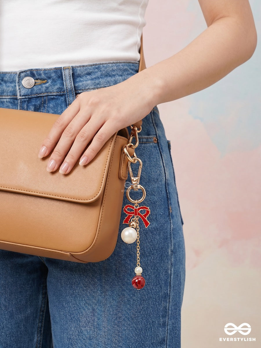 Bowtique – Satin Bow Bag Charm With Ruby Crystal Drop