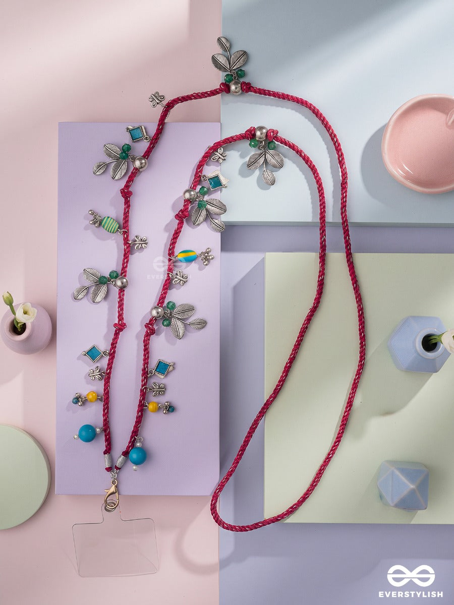 Madhuban – Magenta Braided Phone Sling With Oxidised Floral Charms And Turquoise Beads