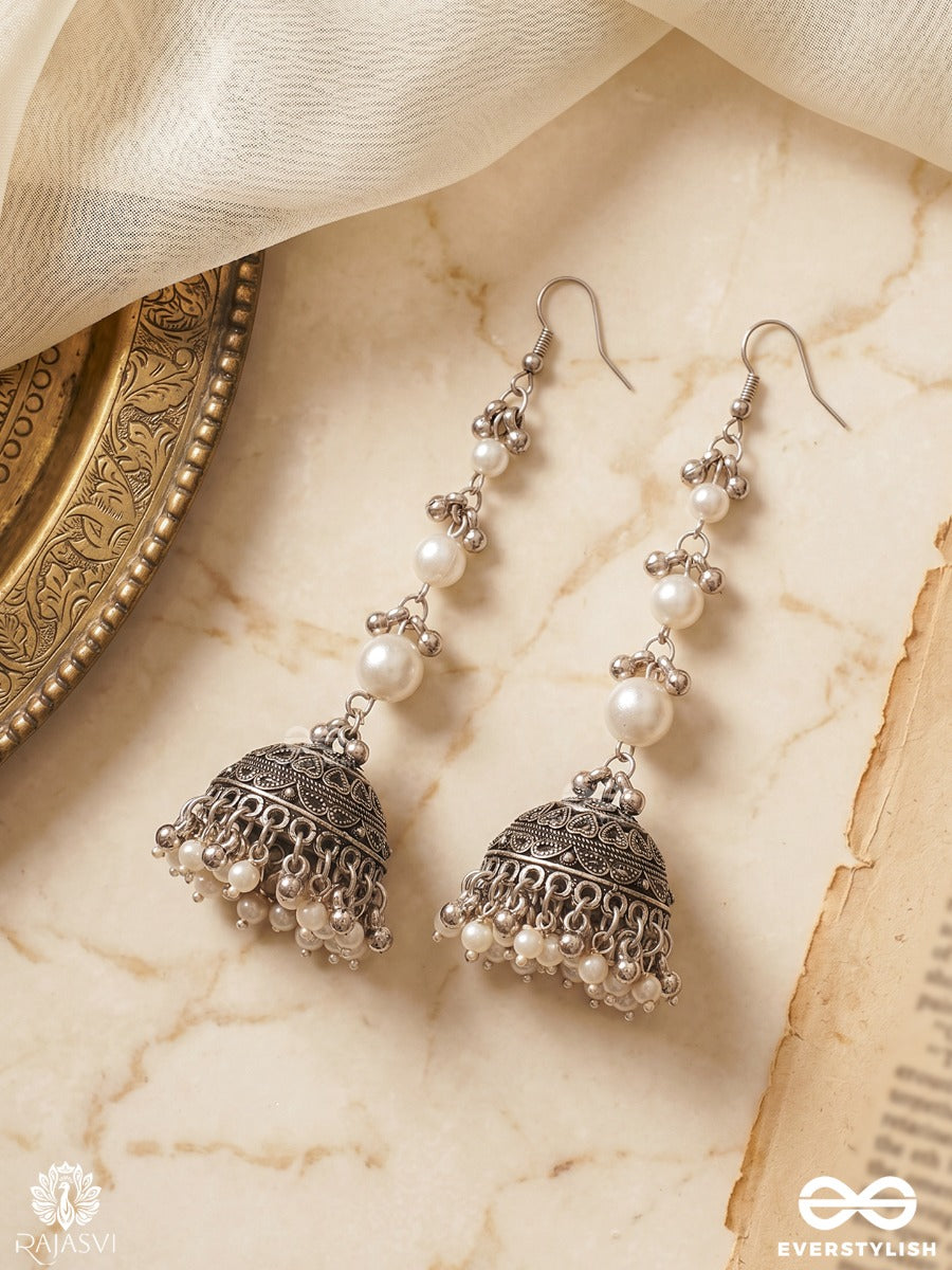 Chandrima – Oxidised Jhumkas With Lustrous Pearl Strands And Carved Dome