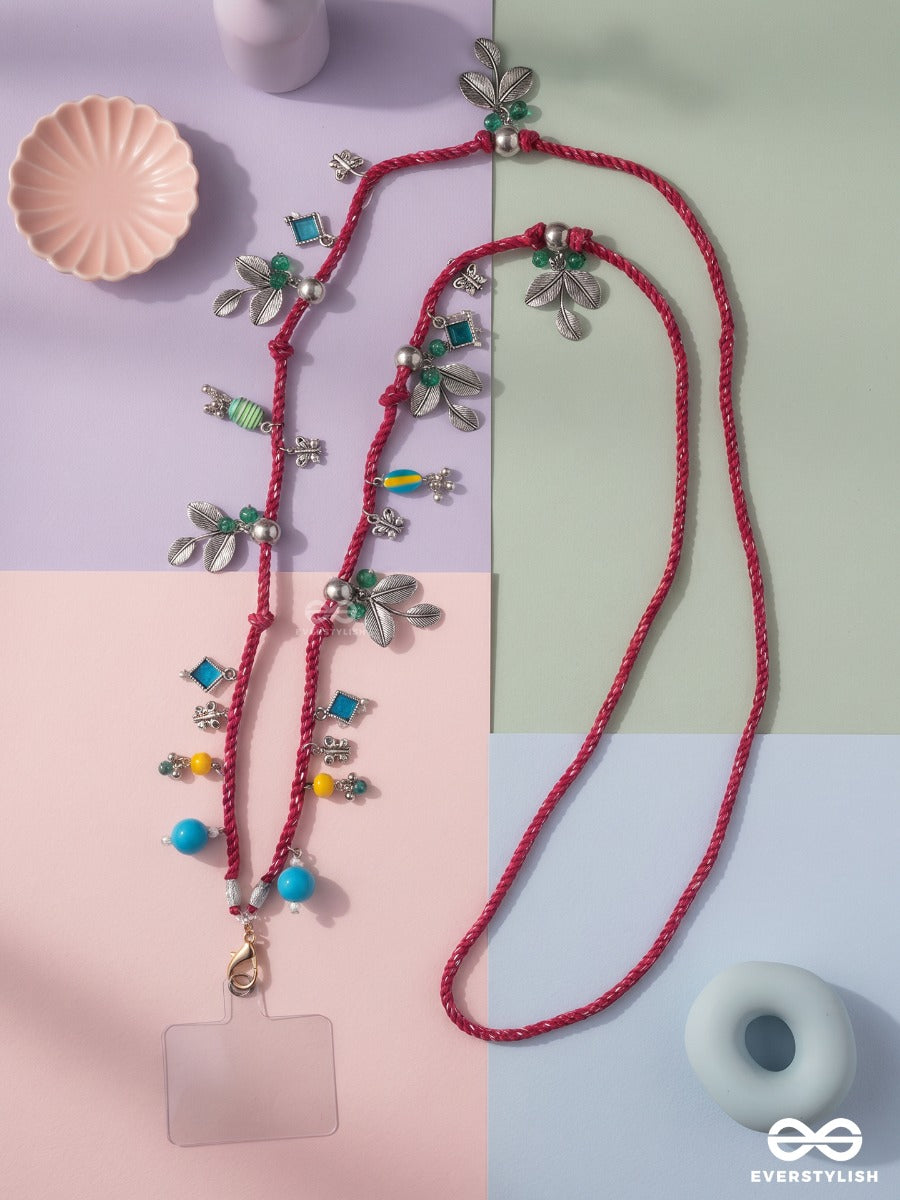 Madhuban – Magenta Braided Phone Sling With Oxidised Floral Charms And Turquoise Beads