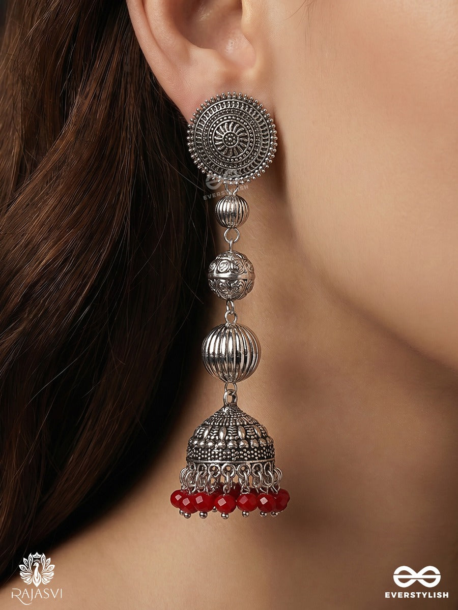 Suryakala – Oxidised Tiered Jhumka Earrings With Radiant Disc Motifs And Ruby Bead Fringe