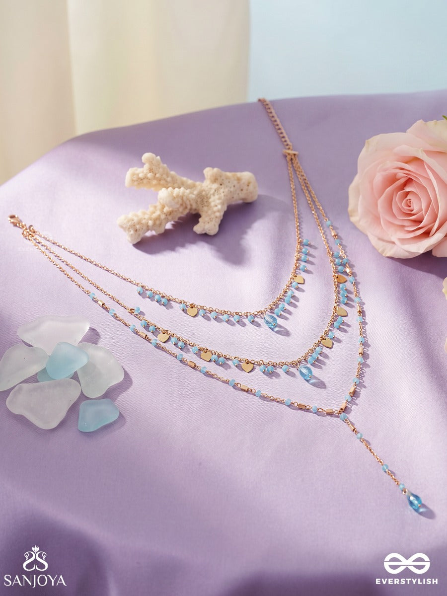Sky Ripple – Triple-Layered Gold-Tone Necklace With Turquoise Bead Accents
