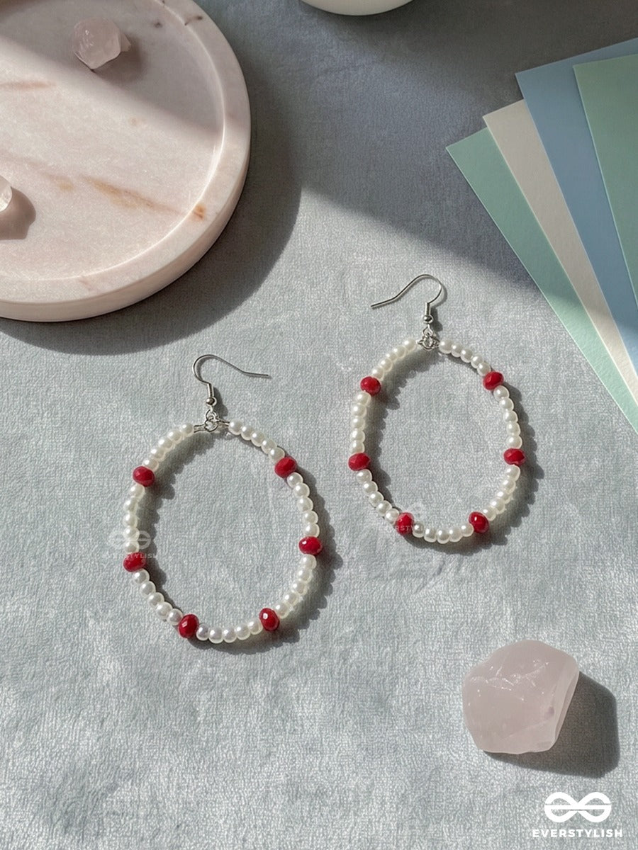 Snow & Ruby – Pearl Oval Hoop Earrings With Crimson Bead Accents