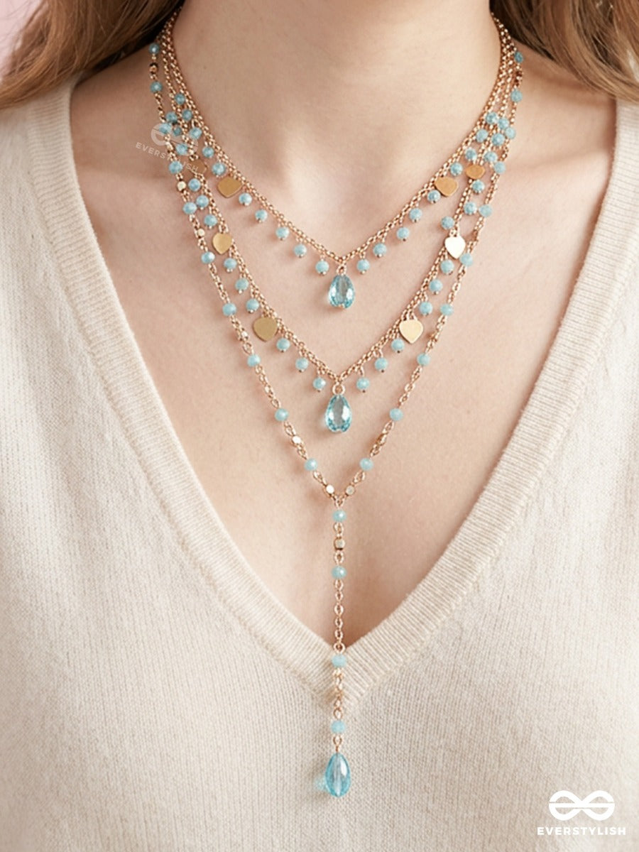 Sky Ripple – Triple-Layered Gold-Tone Necklace With Turquoise Bead Accents