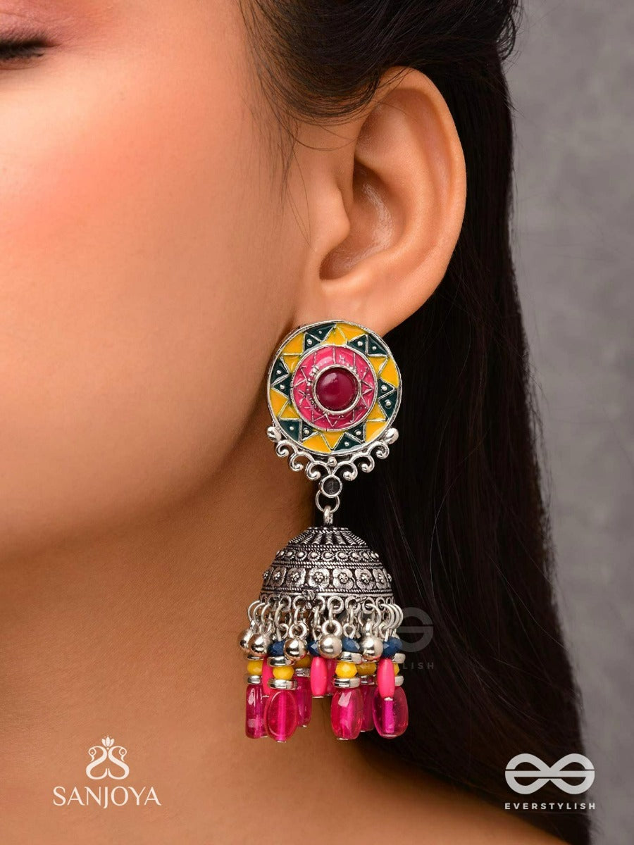 Suryaruchi-Sun's Radiance-Lavish Pink Earrings Enamelled With A Sun Motif And Oxidized Jhumka Adorned With Beads And Ghunghroos