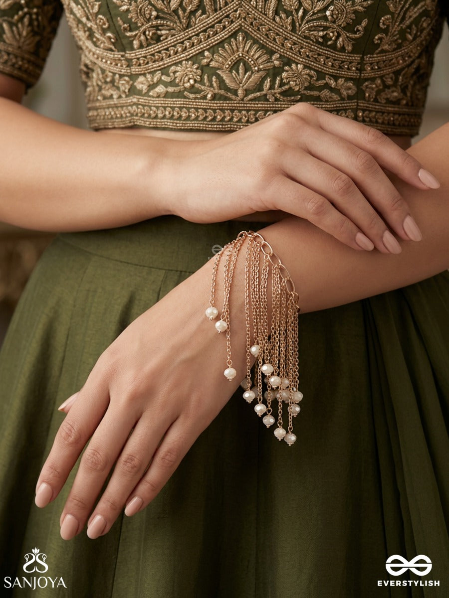 Sajlehra – Adorned Wave – Elegant Hanging Bracelet With Multi-Strand Gold-Tone Chains, Pearl-Like Drop Accents And A Flowing Tassel Finish