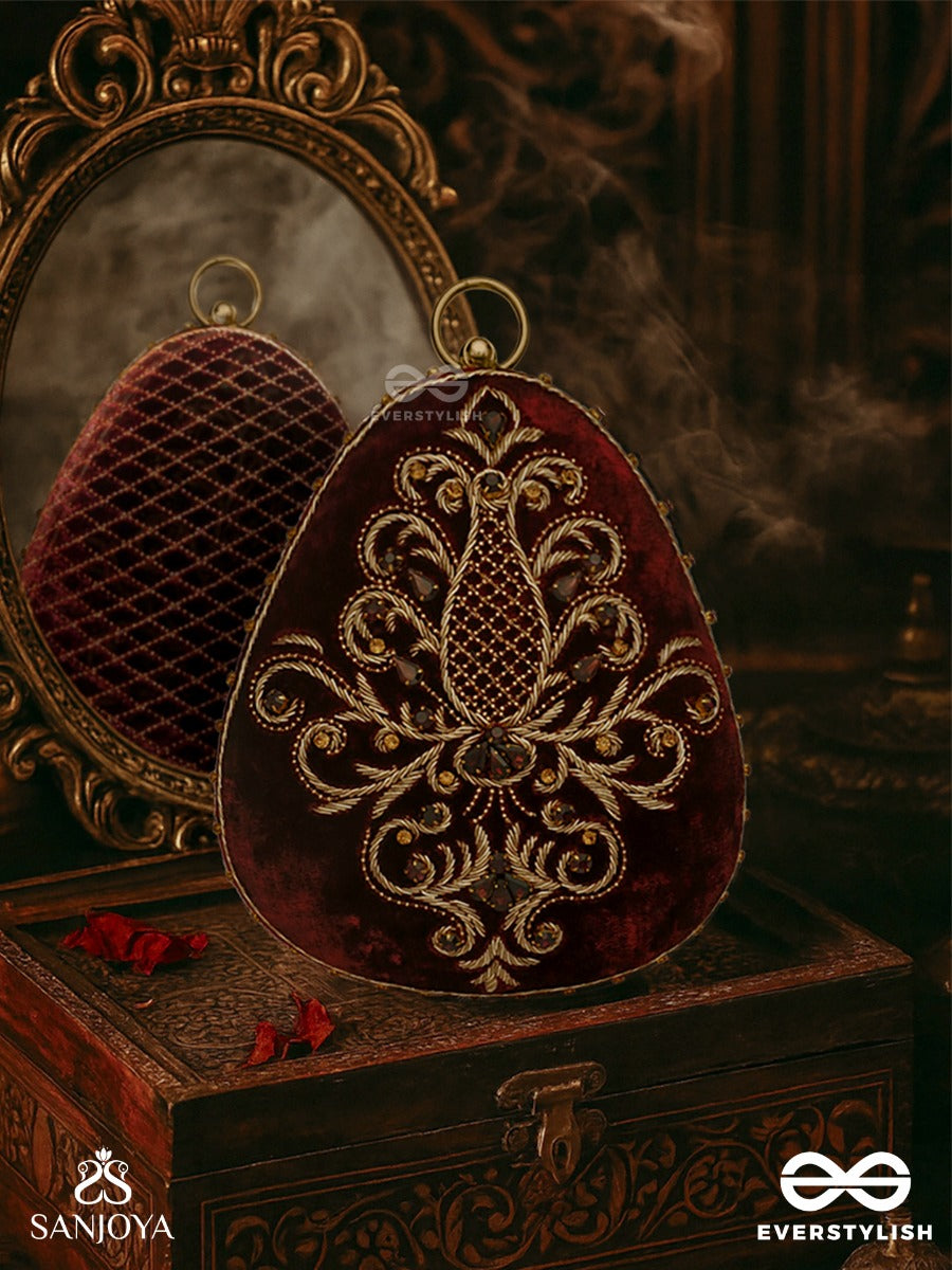 Noor – Oval Maroon Velvet Clutch With Rich Zardozi Embroidery And Golden Metal Frame